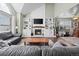 Spacious living room with a fireplace, built-in shelving, and an open floor plan at 10407 Strasburg Way, Parker, CO 80134