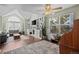 Bright living room with hardwood floors, fireplace, and a large arched window at 10407 Strasburg Way, Parker, CO 80134