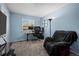 Home office with a large window, computer setup, and a comfortable chair at 10407 Strasburg Way, Parker, CO 80134
