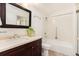 Clean bathroom with single vanity, framed mirror and a shower-tub combination at 3144 S Wheeling Way # 106, Aurora, CO 80014