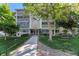 Well-maintained condo building with meticulous landscaping, a walkway and bench seating, inviting guests and residents alike at 3144 S Wheeling Way # 106, Aurora, CO 80014