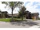 Exterior view of community building with well-manicured lawn and mature trees at 3144 S Wheeling Way # 106, Aurora, CO 80014