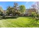 Well-maintained community lawn surrounded by mature trees at 3144 S Wheeling Way # 106, Aurora, CO 80014