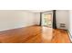 Bright living room with hardwood floors, flowing natural light, and patio door leading to a balcony at 3144 S Wheeling Way # 106, Aurora, CO 80014