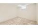 Clean, unfinished basement with neutral carpeting and a single window for light at 613 Hoover Ave, Fort Lupton, CO 80621