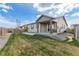 Well-maintained backyard with healthy green grass and a covered patio, perfect for outdoor living at 27957 E 9Th Dr, Aurora, CO 80018
