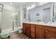 Bathroom featuring a double vanity, modern fixtures, and a glass-enclosed shower for a sleek look at 27957 E 9Th Dr, Aurora, CO 80018