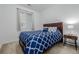 Cozy bedroom with a blue patterned comforter, natural light from the window, and neutral wall color at 27957 E 9Th Dr, Aurora, CO 80018