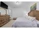 Comfortable bedroom with a well-lit interior, a wooden bed frame, and soft, neutral-toned bedding at 27957 E 9Th Dr, Aurora, CO 80018