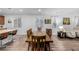 Dining room boasts a large wooden table with seating for eight, complemented by natural light from nearby windows at 27957 E 9Th Dr, Aurora, CO 80018