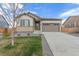 Charming single-Gathering home with a two-car garage, landscaped front yard, and inviting entryway at 27957 E 9Th Dr, Aurora, CO 80018