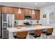 Modern kitchen features stainless steel appliances, granite countertops, and an island with bar seating, perfect for casual dining at 27957 E 9Th Dr, Aurora, CO 80018