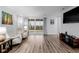 Living room with hardwood floors, sliding doors, and comfy seating at 27957 E 9Th Dr, Aurora, CO 80018
