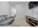 Bright living area with a comfortable sofa, a media center with a large TV, and neutral-toned walls at 27957 E 9Th Dr, Aurora, CO 80018