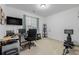 Bright office space with a large window, a desk, and an exercise machine, offering a versatile area at 27957 E 9Th Dr, Aurora, CO 80018