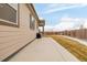 Wide patio with a view of the home's exterior, complimented with a large lawn at 27957 E 9Th Dr, Aurora, CO 80018