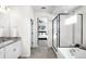 Main bathroom with double vanity, shower, and tub at 9392 Anvil St, Arvada, CO 80007