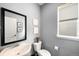 Small bathroom with pedestal sink, toilet, and small window at 9392 Anvil St, Arvada, CO 80007