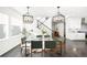 Modern dining room with glass table, gray chairs, and hardwood floors at 9392 Anvil St, Arvada, CO 80007