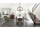 Bright dining room features a spacious table, chandelier, and hardwood floors at 9392 Anvil St, Arvada, CO 80007