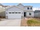 Two story home with attached garage and landscaped yard at 9392 Anvil St, Arvada, CO 80007