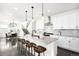 Open concept kitchen with white cabinets, granite countertops, and breakfast bar at 9392 Anvil St, Arvada, CO 80007