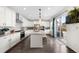 Modern kitchen with large island, stainless steel appliances, and ample cabinet space at 9392 Anvil St, Arvada, CO 80007