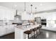 Modern kitchen with white cabinets, granite countertops, and large island at 9392 Anvil St, Arvada, CO 80007