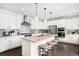 Modern kitchen with large island, stainless steel appliances, and ample cabinet space at 9392 Anvil St, Arvada, CO 80007