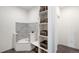 Modern laundry room with built-in pet shower and storage shelves at 9392 Anvil St, Arvada, CO 80007