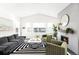 Spacious living room with fireplace, large windows, and stylish furniture at 9392 Anvil St, Arvada, CO 80007