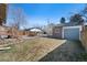 Landscaped backyard with stone patio, detached garage, and plenty of green space at 772 Garfield St, Denver, CO 80206