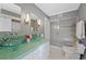 Well-lit bathroom showcasing dual glass vessel sinks, modern fixtures, and a glass-enclosed shower at 772 Garfield St, Denver, CO 80206