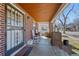 Inviting covered front porch featuring brick pillars and a decorative security door at 772 Garfield St, Denver, CO 80206