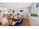 Light-filled dining room featuring stylish lighting, a large table and hardwood floors at 772 Garfield St, Denver, CO 80206