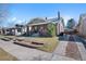 View of a single Gathering home with brick exterior, mature trees and a driveway at 772 Garfield St, Denver, CO 80206