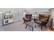 Inviting sitting area featuring comfortable chairs, an ottoman, a play kitchen and a built in bookcase at 772 Garfield St, Denver, CO 80206