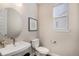 Powder bathroom featuring a sink and fixtures, with a window for natural light at 5381 Hickory Oaks Trl, Castle Rock, CO 80104