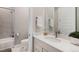 Bright bathroom featuring white cabinets, white countertops, a framed mirror, and a shower at 5381 Hickory Oaks Trl, Castle Rock, CO 80104