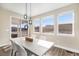 Stylish dining area with modern pendant lighting, large windows, and sliding glass doors to an outdoor space at 5381 Hickory Oaks Trl, Castle Rock, CO 80104