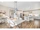 Open-concept dining area featuring stylish lighting and seamless integration with a modern kitchen at 5381 Hickory Oaks Trl, Castle Rock, CO 80104