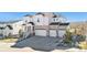 Inviting two-story home with a three-car garage, stone accents, and manicured landscaping at 5381 Hickory Oaks Trl, Castle Rock, CO 80104