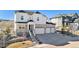 Beautiful two-story home featuring a three-car garage, stone accents, and well-maintained landscaping at 5381 Hickory Oaks Trl, Castle Rock, CO 80104