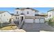 Striking exterior of a two-story home with a three-car garage and manicured landscaping at 5381 Hickory Oaks Trl, Castle Rock, CO 80104