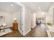 Bright hallway featuring hardwood floors, neutral walls, and open access to the living spaces at 5381 Hickory Oaks Trl, Castle Rock, CO 80104