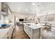 Modern kitchen island with quartz countertops, stainless steel appliances, and open to living spaces at 5381 Hickory Oaks Trl, Castle Rock, CO 80104