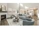 Spacious living room featuring a fireplace, tall windows, comfortable seating, and an open floor plan at 5381 Hickory Oaks Trl, Castle Rock, CO 80104