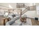 Bright living room with soaring ceilings, a staircase, and an open layout connecting to the kitchen at 5381 Hickory Oaks Trl, Castle Rock, CO 80104