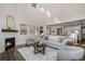 Bright living room with fireplace, wood floors, and open-concept layout at 5381 Hickory Oaks Trl, Castle Rock, CO 80104