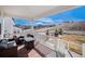 Relaxing porch with comfortable seating overlooking a scenic vista with mountain views at 5381 Hickory Oaks Trl, Castle Rock, CO 80104